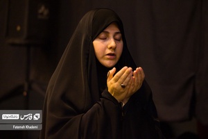 خانمی که در حال نماز خواندن است.