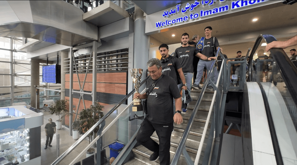 گزارش تصویری؛  قهرمانان کشتی ایران با استقبال خادمان حرم بانوی کرامت وارد کشور شدند